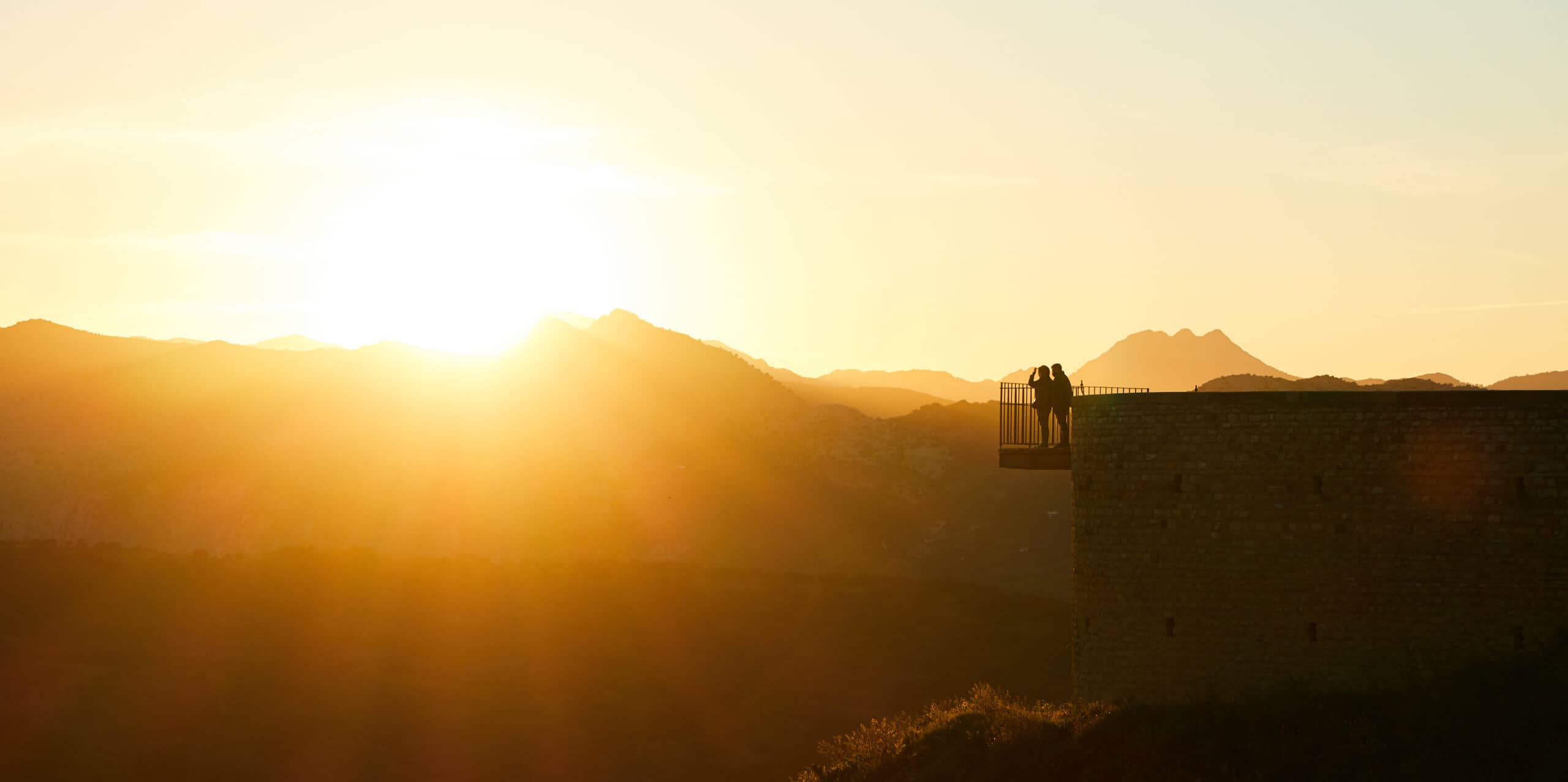 Two people standing on a balcony overlooking the Serranía de Ronda