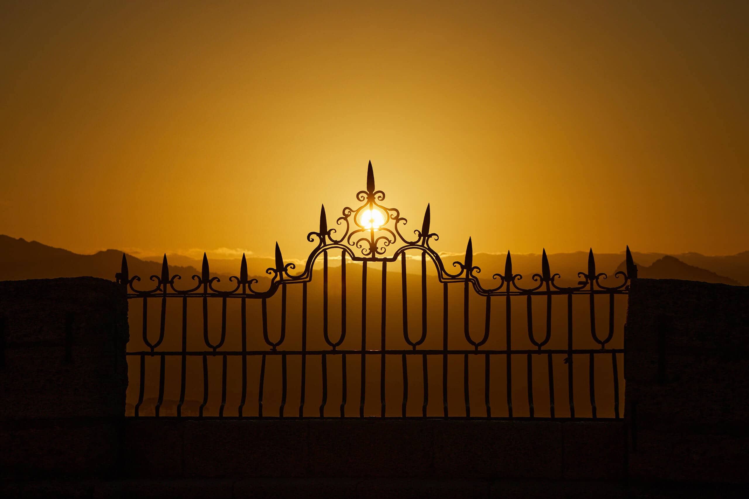 Railings in a park in Ronda at sunset