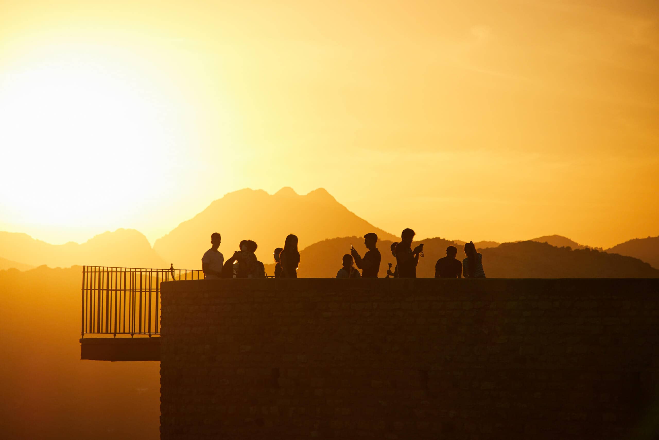 Group of people photographing a sunset in Ronda