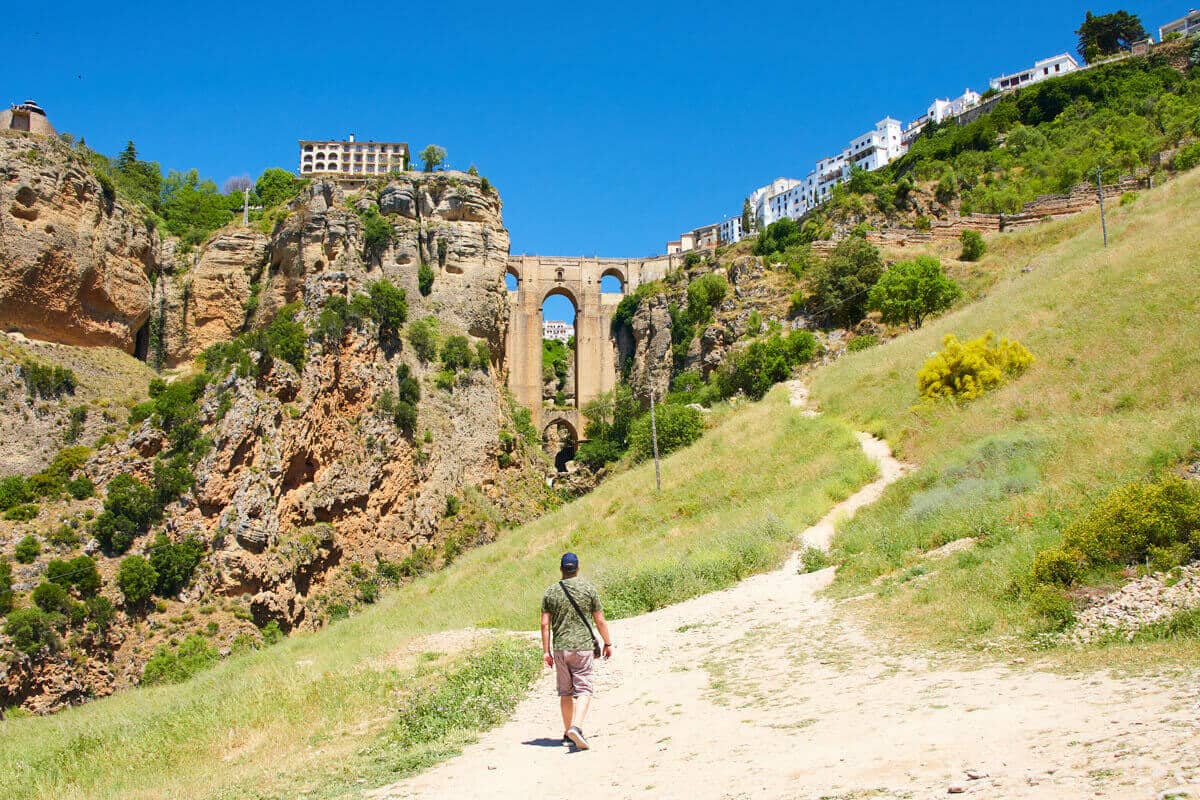 Man walking towards Puente Nuevo